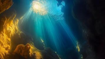 Underwater sunlight through a cave, creating ethereal light and shadow patterns photo