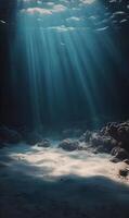 Sunlight filtering through the ocean water illuminating the sandy seabed floor photo