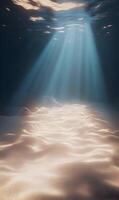 Mesmerizing underwater scene with sunbeams illuminating the seabed's sandy texture photo