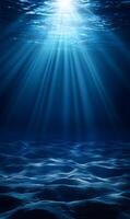 Underwater light rays illuminating sandy ocean floor creating ethereal ambience photo