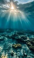 Underwater sunlight filtering through the ocean surface illuminating the sea floor view photo