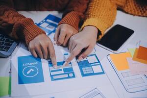 Two people are working on a website design photo