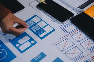 A person is using a smartphone to design a website photo
