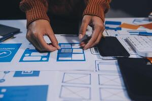 A person is working on a design project on a table photo