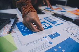 A person is working on a laptop with a blue and white design photo