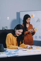 Two women working on a project in an office photo
