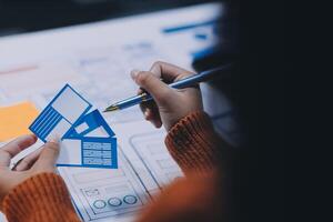 A person is working on a project with a blue piece of paper photo
