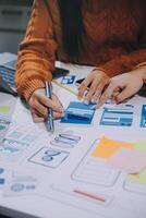 A woman is working on a design project with a laptop photo