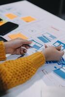 A person is working on a design project on a table photo