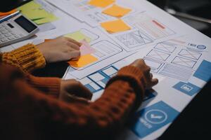 A person is working on a project with sticky notes photo