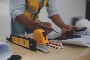 A man in a hard hat and vest is working on a project photo