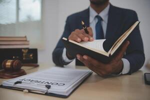 A man in a suit is writing on a legal document photo