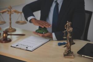 A man in a suit is holding a statue of justice photo