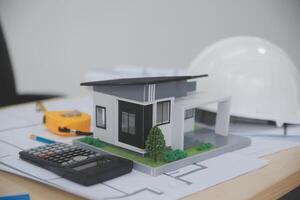 A model of a house sitting on top of a desk photo