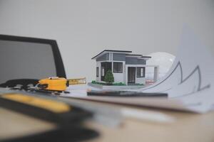 A small house model sits on top of a table photo