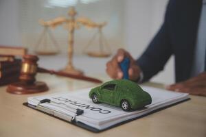 A man in a suit is signing a contract with a car on it photo