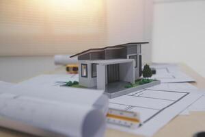 A model of a house sitting on top of a desk photo