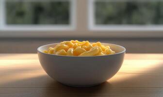 a bowl of macaroni and cheese sitting on a table photo