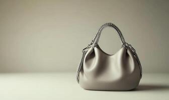 A purse with a chain strap is on a table photo