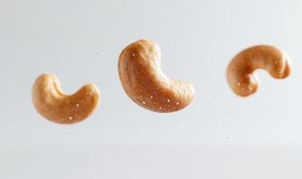 Three cashews are flying in the air closeup photo