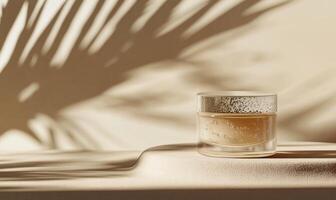 a jar of cream sitting on a table with a shadow of a palm tree photo