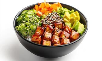 A black bowl of food with tofu, avocado, and vegetables photo