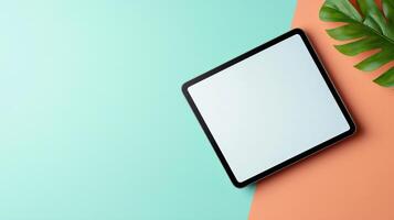 A tablet is on a green and orange background photo