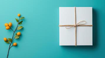 A white box with a brown string tied around it is on a blue background photo