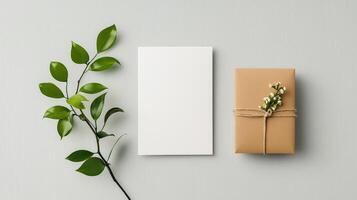 A white card with a leaf on it sits next to a brown box photo