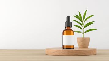 A bottle of essential oil is on a wooden table next to a potted plant photo