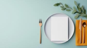 A white plate with a fork, knife and spoon on it photo