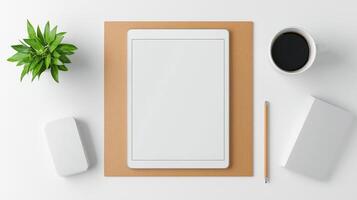A white tablet sits on a wooden surface with a pen and a cup of coffee photo