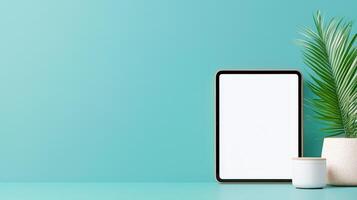 Minimalist A White Tablet Sits on a Table Next to a Potted Plant photo