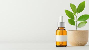 A bottle of essential oil is on a table next to a plant photo