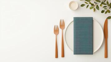 A white plate with a blue napkin and wooden utensils photo