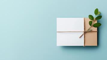A white card with a brown ribbon and a leaf on top photo