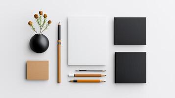 A white and black design with a vase, pens, pencils, and a notebook photo