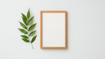 A white frame with a leaf on top of it photo