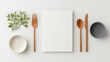 A minimal white plate with a fork, knife and spoon on it photo