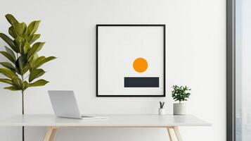 A white desk with a laptop and a framed picture of an orange sun photo