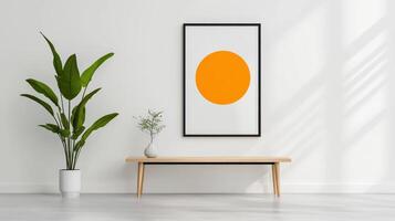 A white wall with a black frame and a picture of an orange circle photo