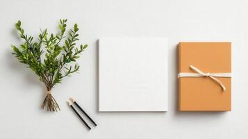A white box with a ribbon tied around it sits on a table next to a pencil photo
