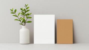A white square with a green leaf in a white vase photo