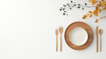 A wooden table with a white plate and utensils on it photo