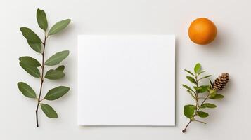 A white square with a leaf on it and an orange on top photo