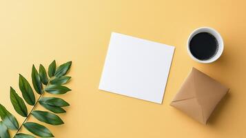 A white card with a leaf on it sits on a yellow background photo