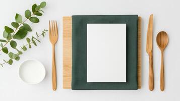 A table setting with a white napkin, fork, knife, and spoon photo