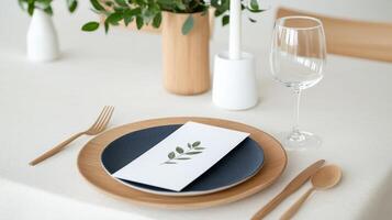 A table setting with a blue plate, a white napkin, a fork, a knife, and a spoon photo