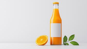 A glass bottle of orange juice with a slice of orange on the table photo