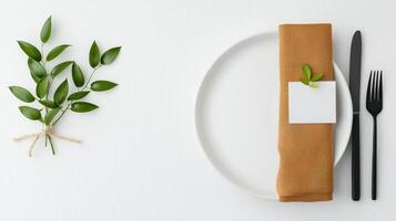 A white plate with a brown napkin and a fork and knife on it photo
